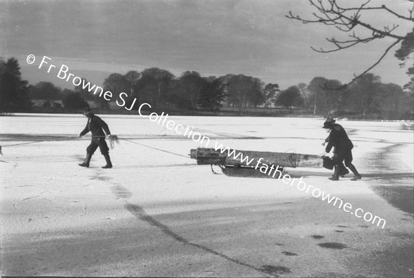 TAKING LOG ACROSS FROZEN LAKE